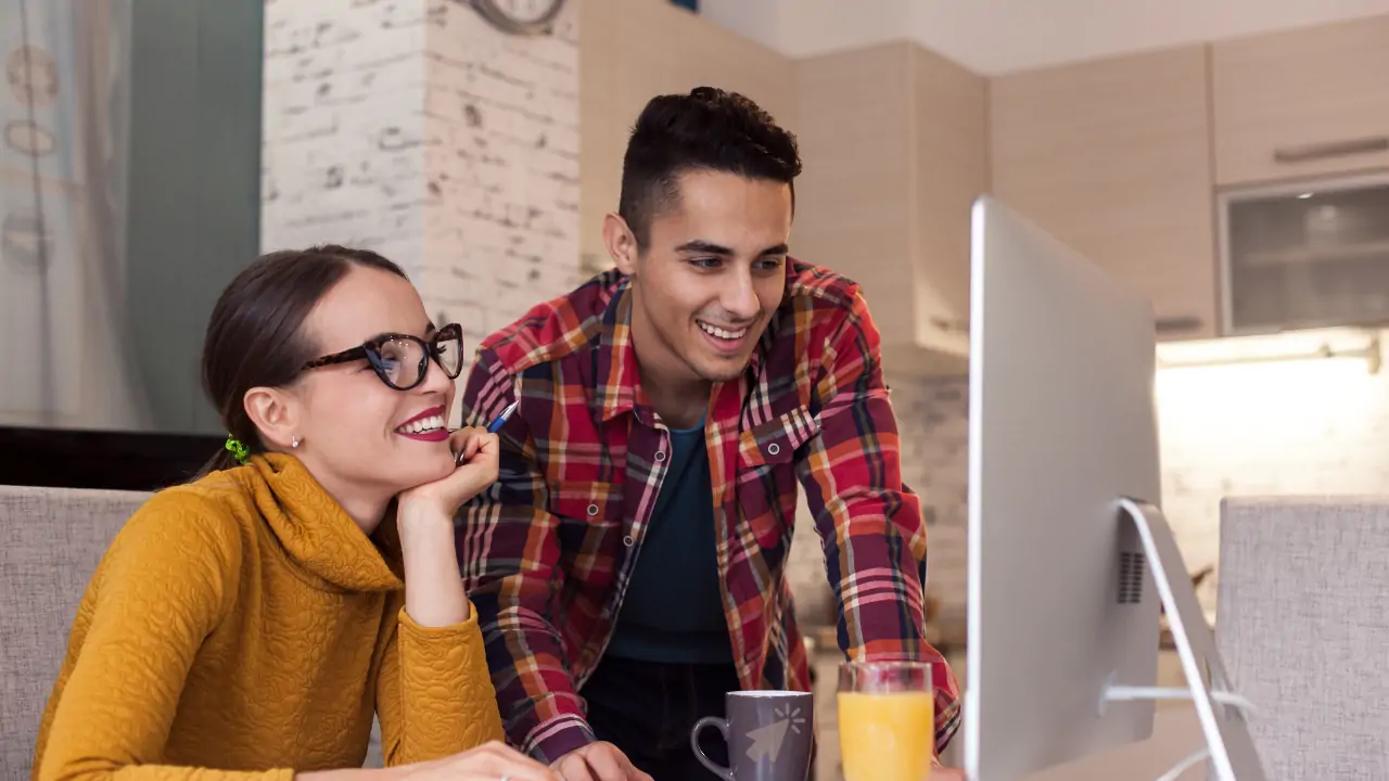 A boy and girl working together on a computer